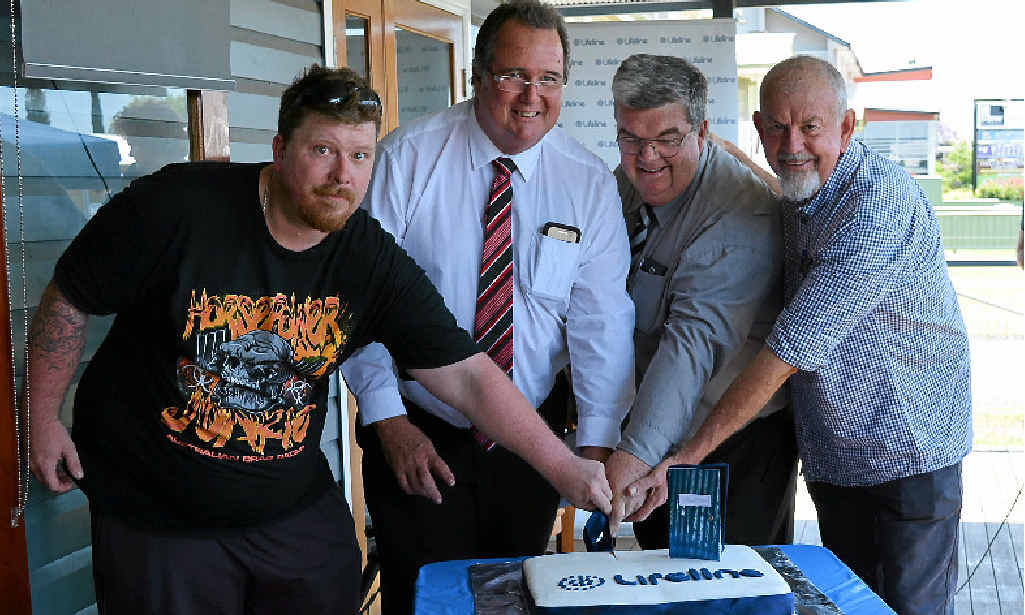 HOUSEWARMING: Andrew Skilton, Mayor Peter Blundell, Lifeline Darling Downs CEO Derek Tuffield and Mentors Services senior practitioner Terry Pinney cut the cake at the official opening.